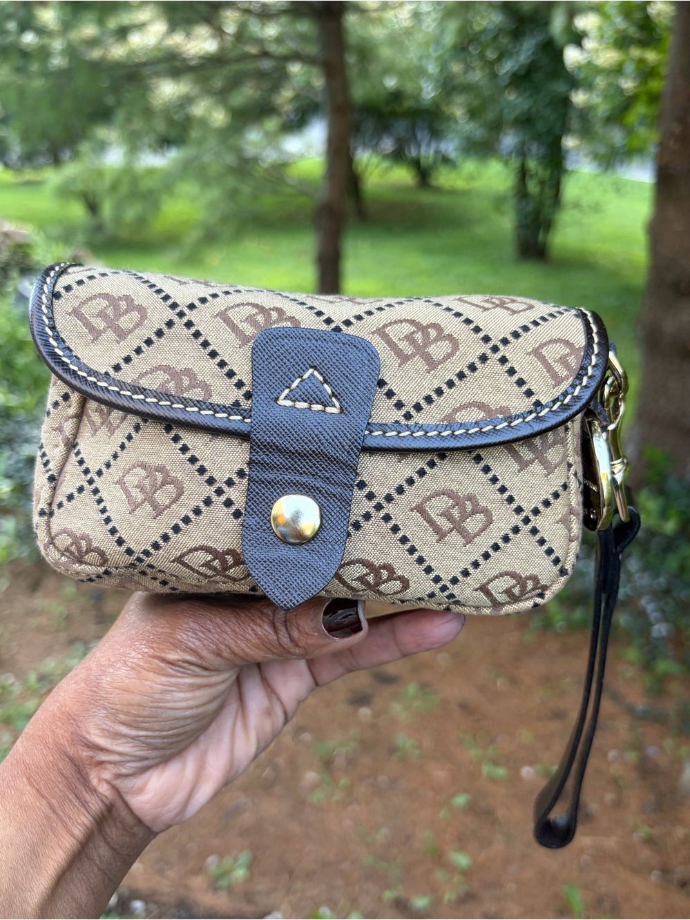 Dooney & Bourke Beige and Brown Monogram Wristlet Clutch With Blue Duck Charm